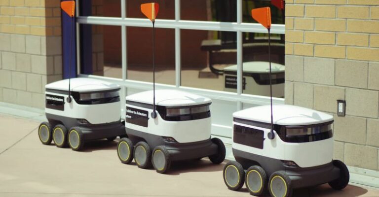 Autonomous Robots - Delivery Robots Parked Beside Glass Window