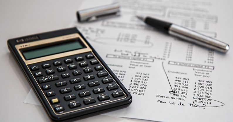Budget - Black Calculator Near Ballpoint Pen on White Printed Paper